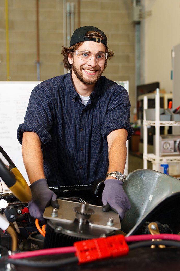 A person working on a race kart