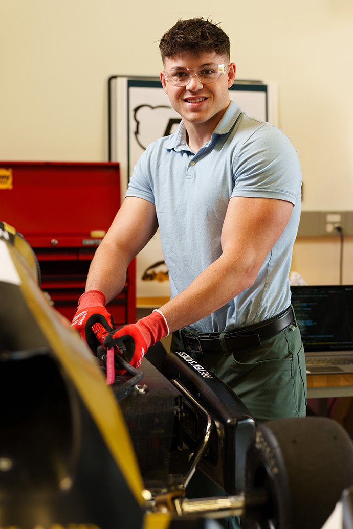 A person working on a race kart