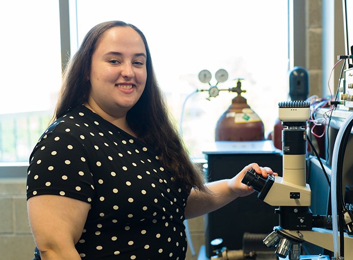 A girl holding a microscope