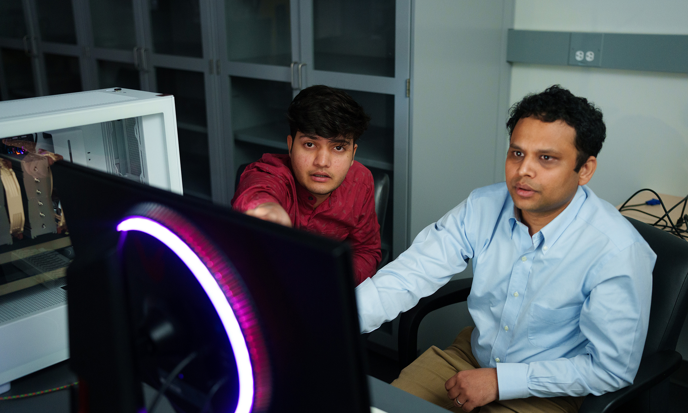 Two people working on a computer