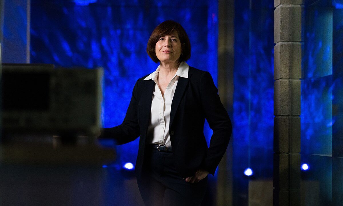 Woman standing with blue lights in background