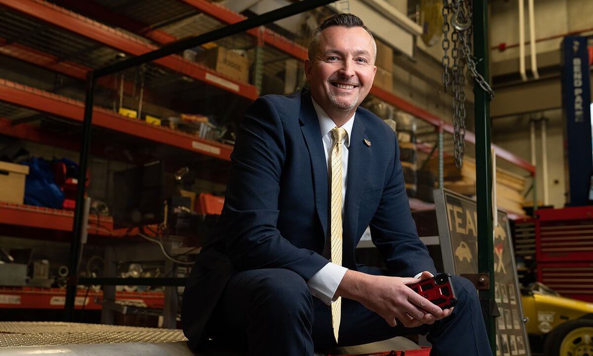 Man sitting on bench in warehouse