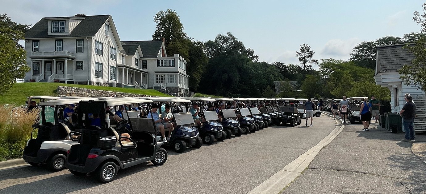 A row of golf carts on the street