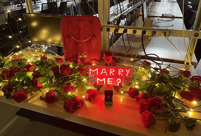 An engagment ring and roses in a lab.