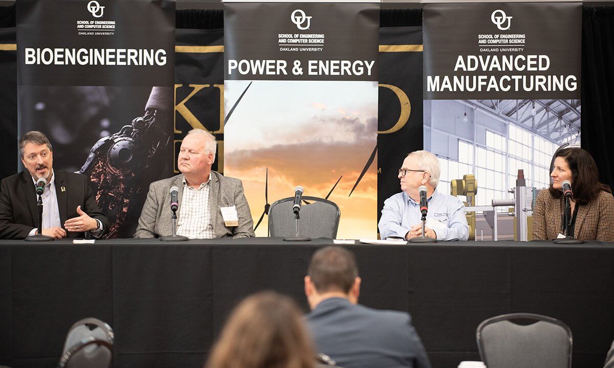 A group of people sitting in a panel.