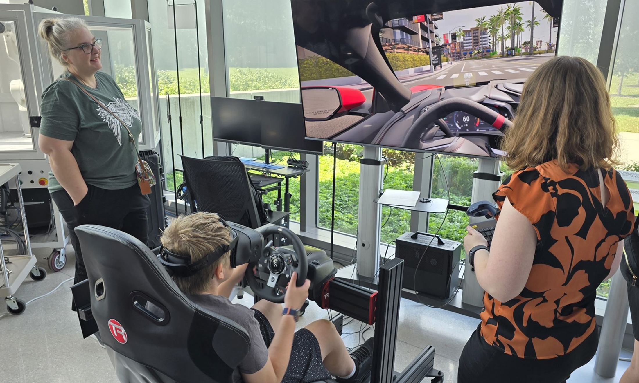 People using a virtual reality driving simulator