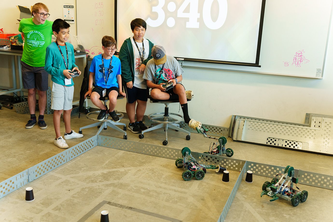 Image of Robotics camp participants engaged in testing.