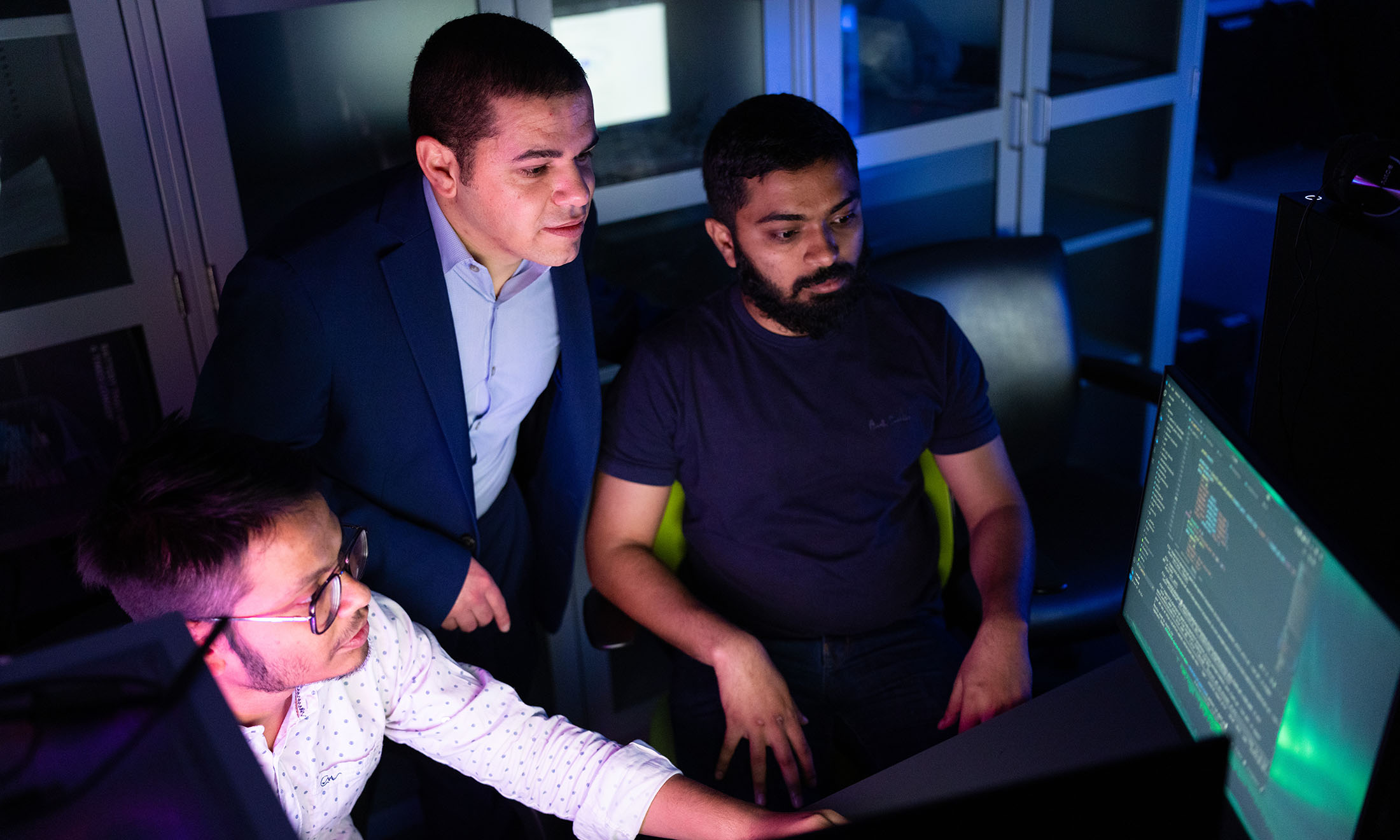 a professor and students looking at the screen that displays algorithms
