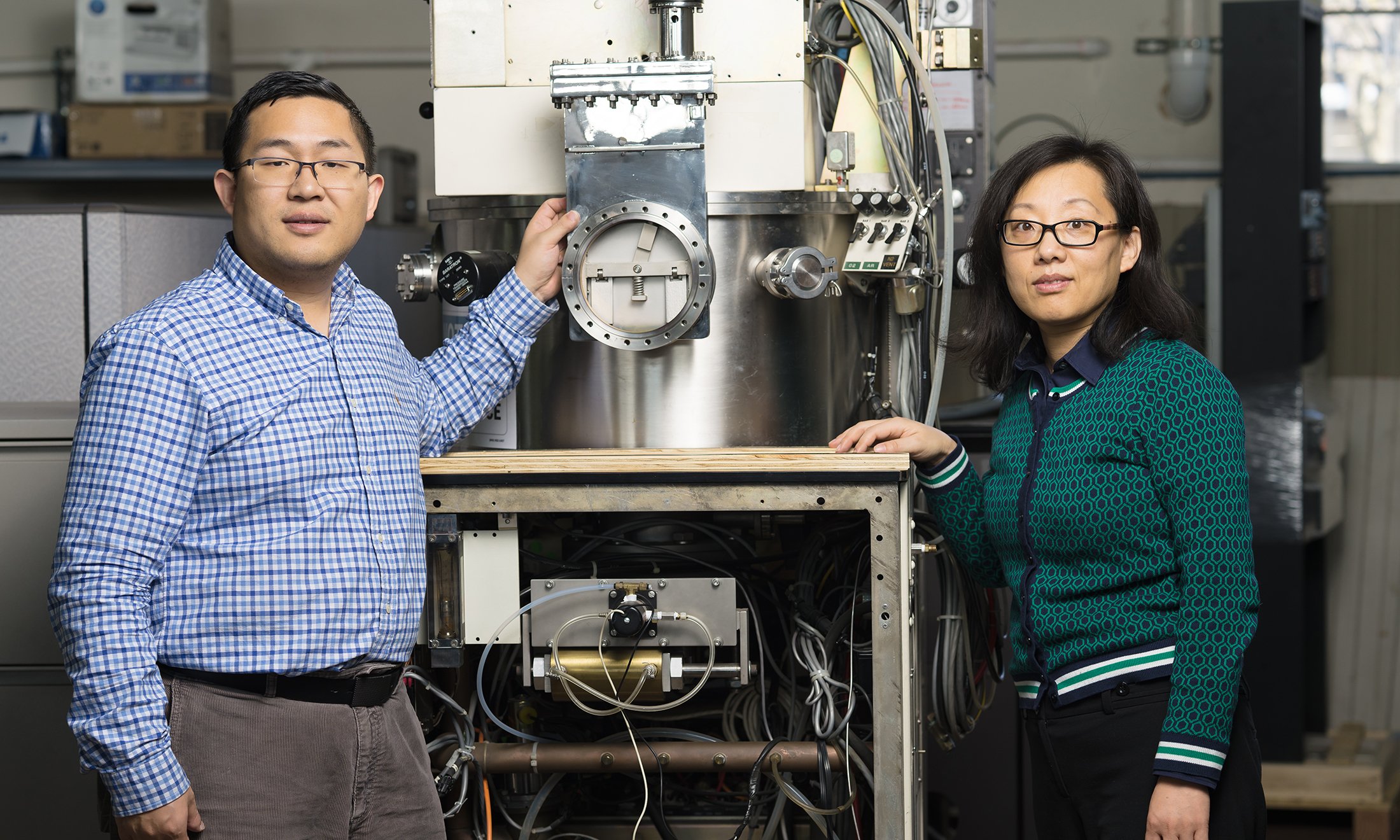 Two people posing with lab equipment