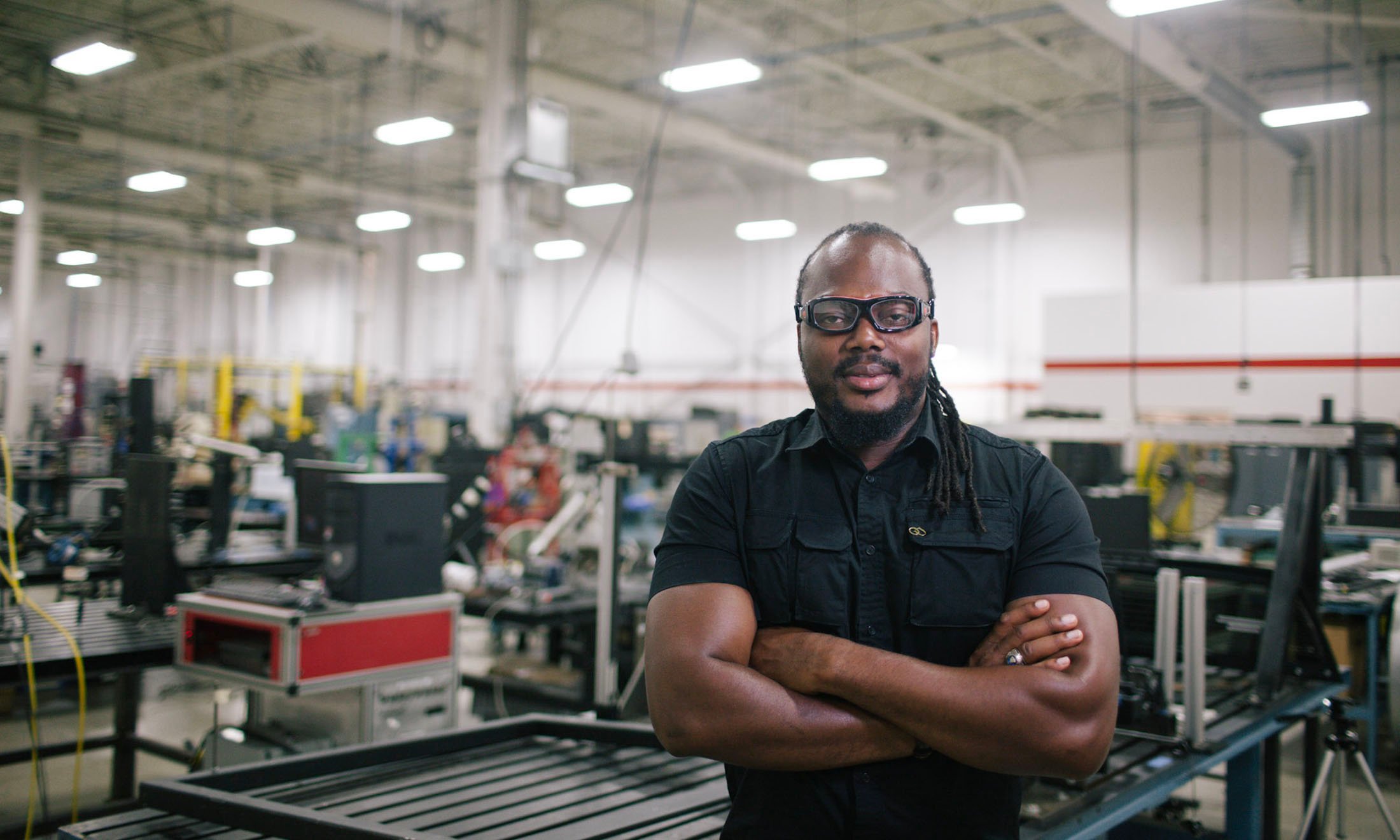 A man with his arms crossed in a lab