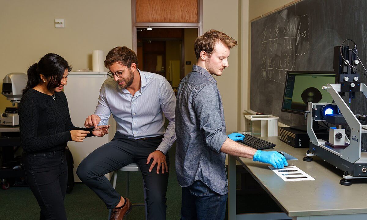 Three people working in a lab