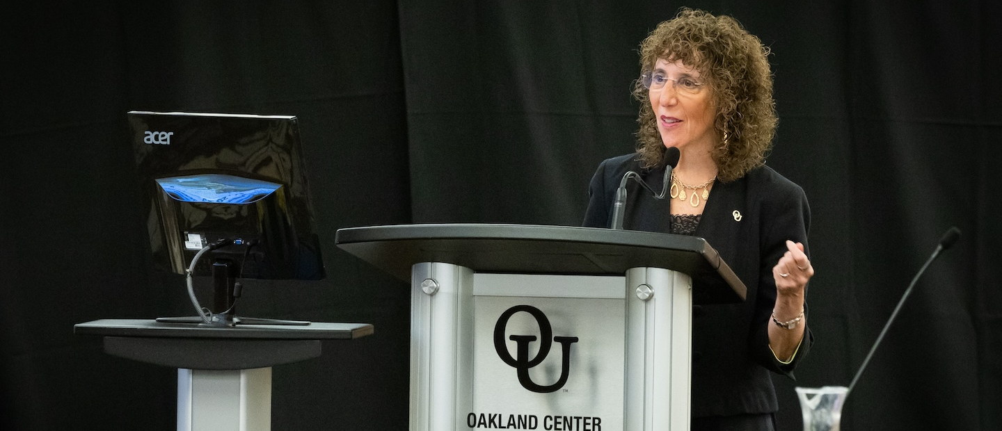 Ora Hirsch Pescovitz speaking at a podium