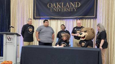 Four people standing behind a table on a stage
