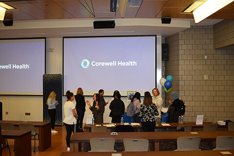 A group of people standing and talking together.