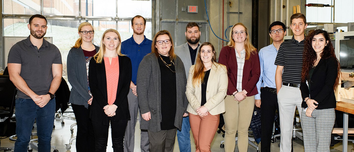 A group of people in a lab, posing for a photo.