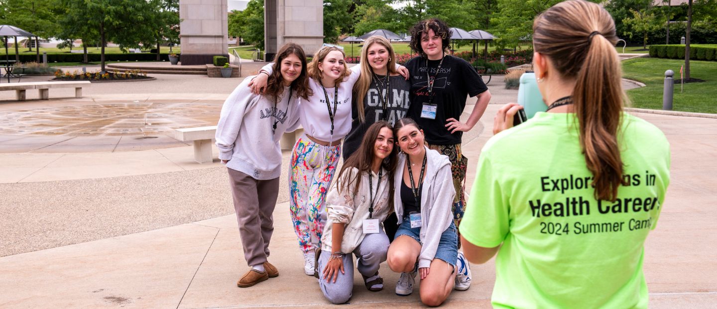 Young students taking a photo with a group leader