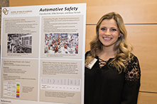 image of Ciara Bazinski standing next to her research poster