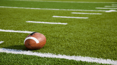 A football sitting on a football field