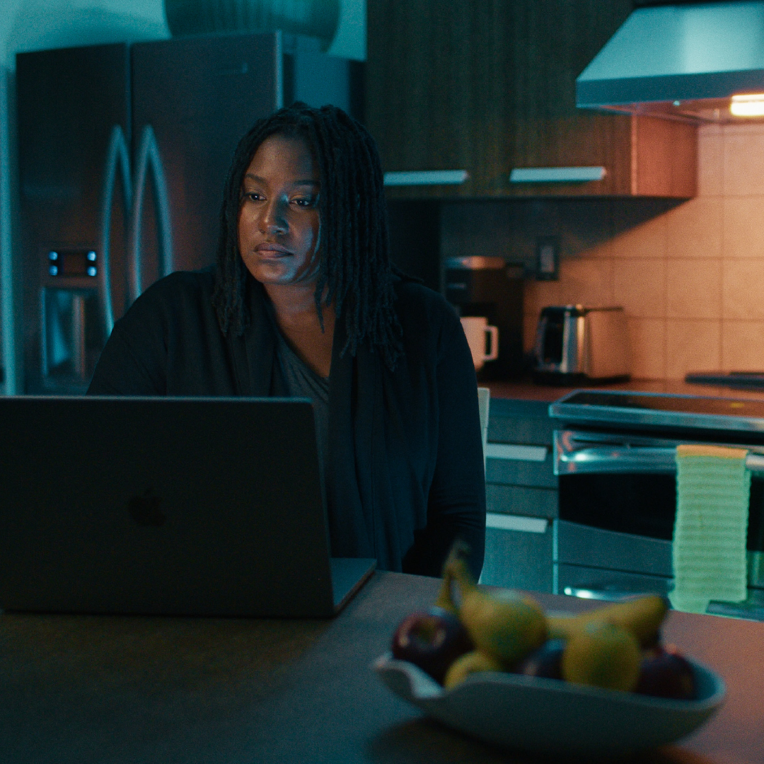 Oakland University graduate, Ashlee, studying on a laptop