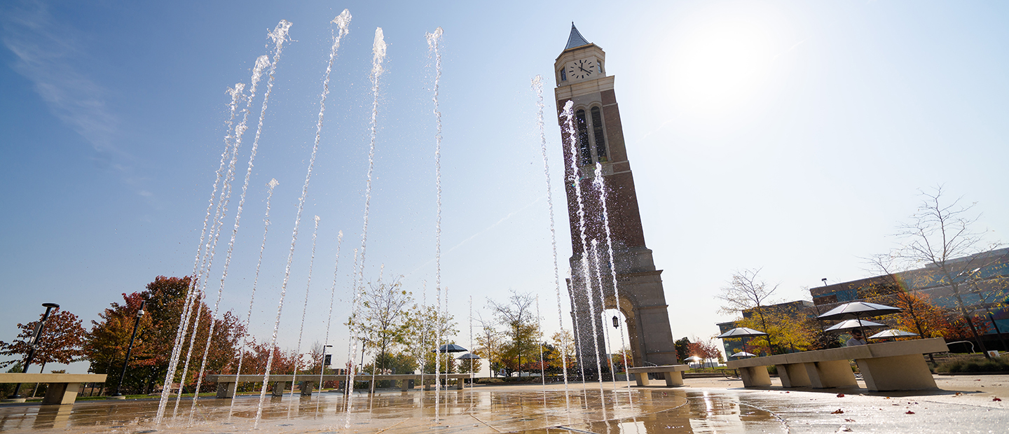 Tall streams of water in a fountain in front of Elliott Tower on Oakland University's campus.