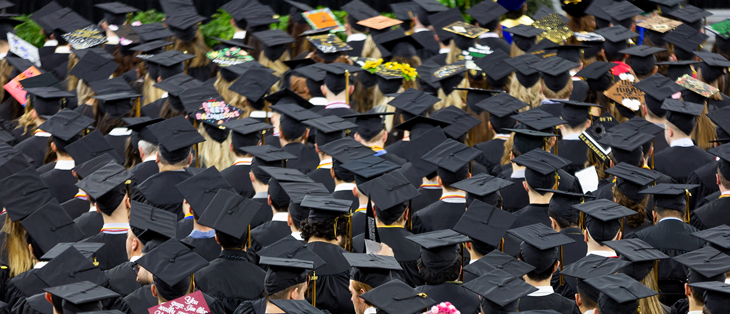 aerial photo of many graduates wearing black graduation caps